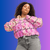 Plus-sized woman wearing breast cancer awareness crop top hoodie
