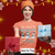 Woman wearing a Christmas-themed t-shirt with snowmen and text with Ovaian Cancer and Shop by Tee, holding gifts against a festive background.